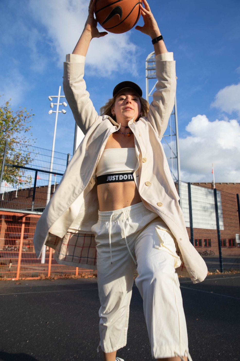 Marije on a basketball court, arms up